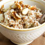 Cozy Mornings: Warm Quinoa Bowl with Crunchy Nuts Delight